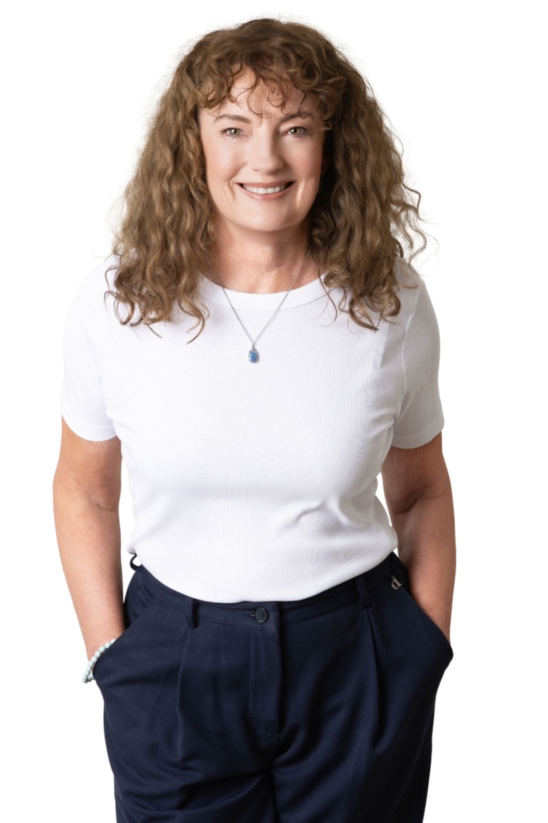 Christina Coghlan smiling in a white T-shirt